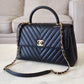 CHANEL Black Caviar Chevron Large Coco Handle 29 cm Flap Bag Brushed Gold Hardware